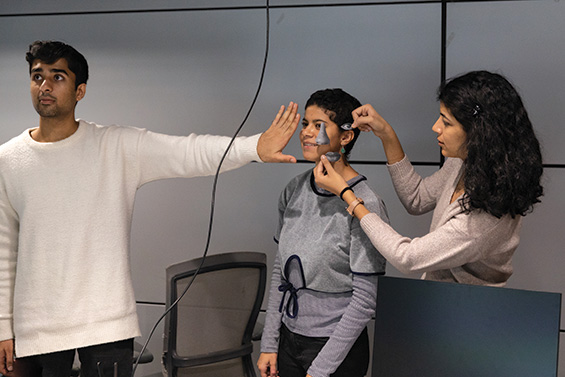 Students using masks to test facial recognition software.