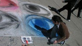 A Saturday Program student works in chalk outside the Foundation Building