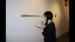 A visitor to the opening night of "Room for Learning" examines a piece by Gabriel Rodriguez-Fuller