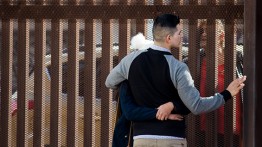 Talking through a U.S.-Mexico border wall. Photo by Stephanie Restrepo