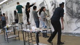 Current members of the Student Portfolio class create large-scale charcoal drawings