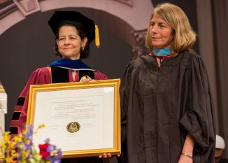 Rachel Warren, chair of the Board of Trustees, awarded an honorary degree to Sacha Pfeiffer.