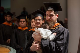Anthony Ziad al-Assal, a graduate student in mechanical engineering, received his diploma with baby in tow.