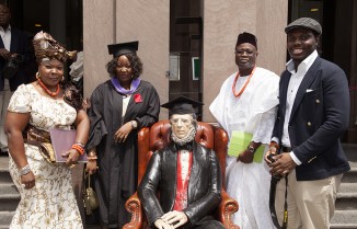Architecture graduate Ezegbebe Eribo poses with her family and Peter Cooper