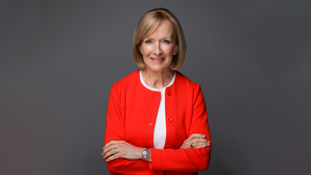 Woman in red jacket with her arms crossed