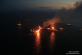 Gasses from the leaking Macondo well are flared at night by Transocean drill ship Discoverer Enterprise and rig Q4000