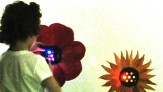 P.S.347 student observing sound-to-light flower LEDs with color filter