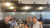 Five members of ENG class of 1976 sit around a table