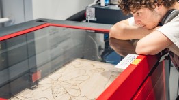 student using laser cutter