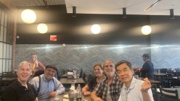Five members of ENG class of 1976 sit around a table
