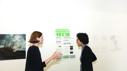 Sophie Schneider, one of the week's organizers, shows the student exhibition to Dr. Ayana Elizabeth Johnson