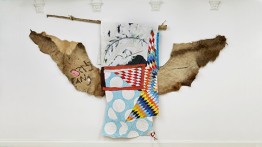 Bang Bang, 2019, elk hide, pine, rope, rabbit fur, acrylic paint, waxed thread, oil stick, cotton, and wool, 84 x 124 inches