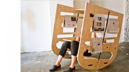 Queer Rocker (2013), CNC prototype oak plywood, rachet straps, newspapers, 48” x 30” x 44”