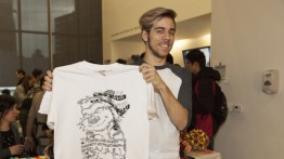 Hunter Mayton (A'2016) holds up an alumnus-designed t-shirt giveaway for student donors