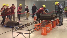 The Cooper Union team watches their work at the National Student Steel Bridge Competition

