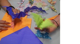 Uyen “Win Win” Nguyen and Jennifer Tashman demonstrate their origami bats