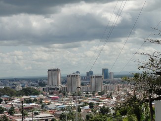 View towards stainless steel arbor with adjacent tinted concrete wall, a solid granite water wall fountain, and a curtain