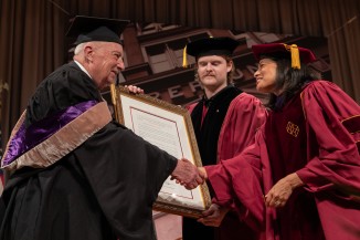 George Reeves ME'64 is awarded a presidential citation, greeted by Student Trustee Elias Dills AR'24 and President Laura Sparks