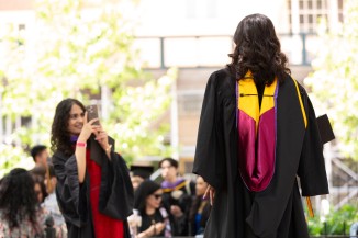 Recent graduates taking pictures in the park