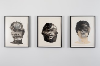 Installation image featuring three ink on paper figurative portraits 