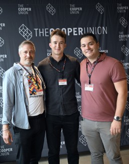 three men in front of Cooper Union sign
