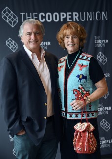 a couple in front of a Cooper Union sign