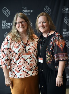 two women in front of a Cooper Union sign