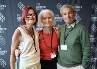 two women and a man in front of a Cooper Union sign