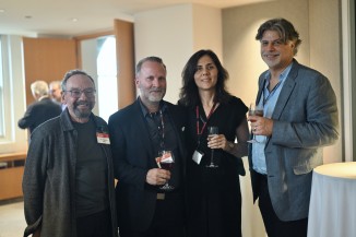 a woman and three men at a party