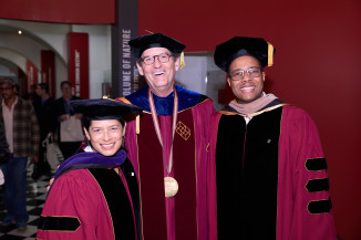 Three people in regalia