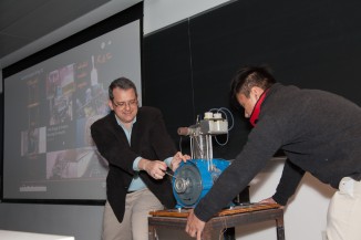 Professor Delagrammatikas with the help of a La Salle student turns on a piston engine
