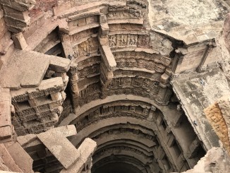 Ornamented brackets for lifting water built along the rim of the well shaft in the Queen's Stepwell, Patan.