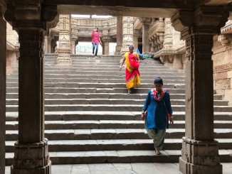 Women descending the stepped corridor at Rudabai vaav.