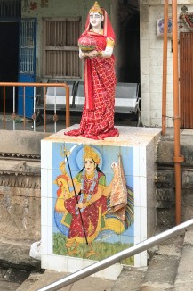 A detail of the female figure holding up a pot at the Maata Bhavani vaav. The pedestal, which is covered with wall tiles depicting an incarnation of the goddess, reflects present day sensibilities. 