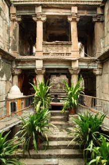 A visitor to the stepwell pauses in the cool depths of its lower levels. In addition to its many shrines, plants tended by local residents are now integral to Maata Bhavani vaav.