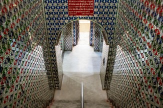 Colorful mirrorwork covers the wall of the Ambe maata vaav near Malav Talav in Ahmedabad, now a temple dedicated to a goddess. Though the stepwell is unrecognizable, it still accesses groundwater seasonally. 