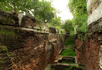 The origins of this stepwell in Bhadaj remain unknown. Its lower levels and main well remain buried, while unbridled vegetation has overtaken what remains above ground. 
