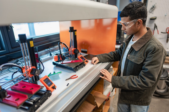 A student operates 3D printers in a Cooper Union fabrication lab.