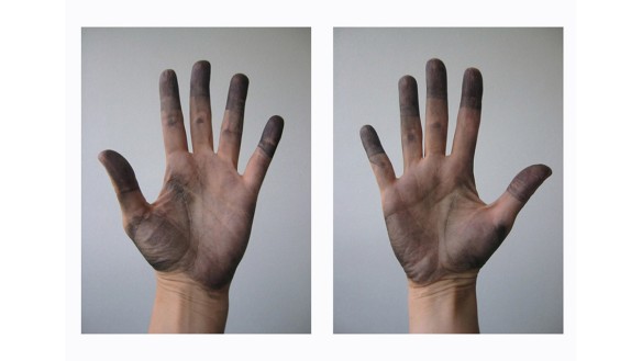 Side-by-side photographs of the palms of two ink-stained hands