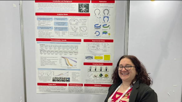 Photo of Professor Michelle Rosen in front of her poster at the IROS Conference.