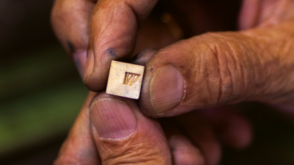 Hand holding small letter