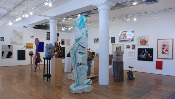 Installation view of gallery with multiple sculptures and art on walls