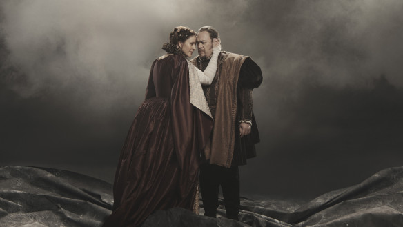 Image of a man and woman embracing with smoke behind them