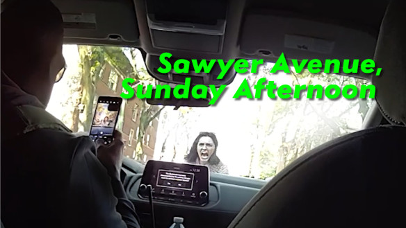 Still from movie looking out from a car at a bystander